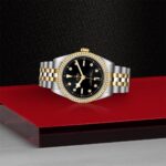 Elegant dual-tone wristwatch with diamond markers on a black dial and gold accents.