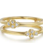 Elegant yellow gold intertwined rings with diamond floral motifs by Gabriel & Co.