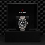 Luxury Tudor watch in elegant black box, showcasing craftsmanship and sleek design.