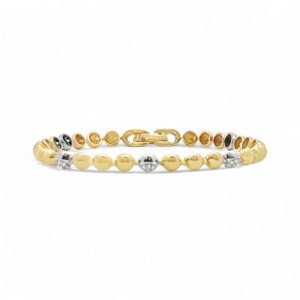 Elegant gold and silver bracelet with polished beads, perfect for versatile, stylish accessorizing.