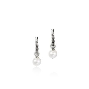 Elegant drop earrings featuring lustrous white pearls and intricate silver chains for timeless style.