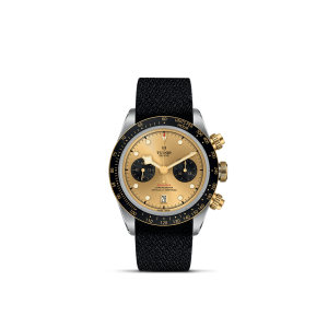Tudor luxury watch with gold dial, black subdials, and textured strap for elegance and performance.